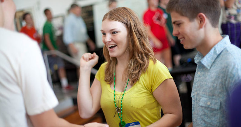 Young girl interacting with other students at orientation
